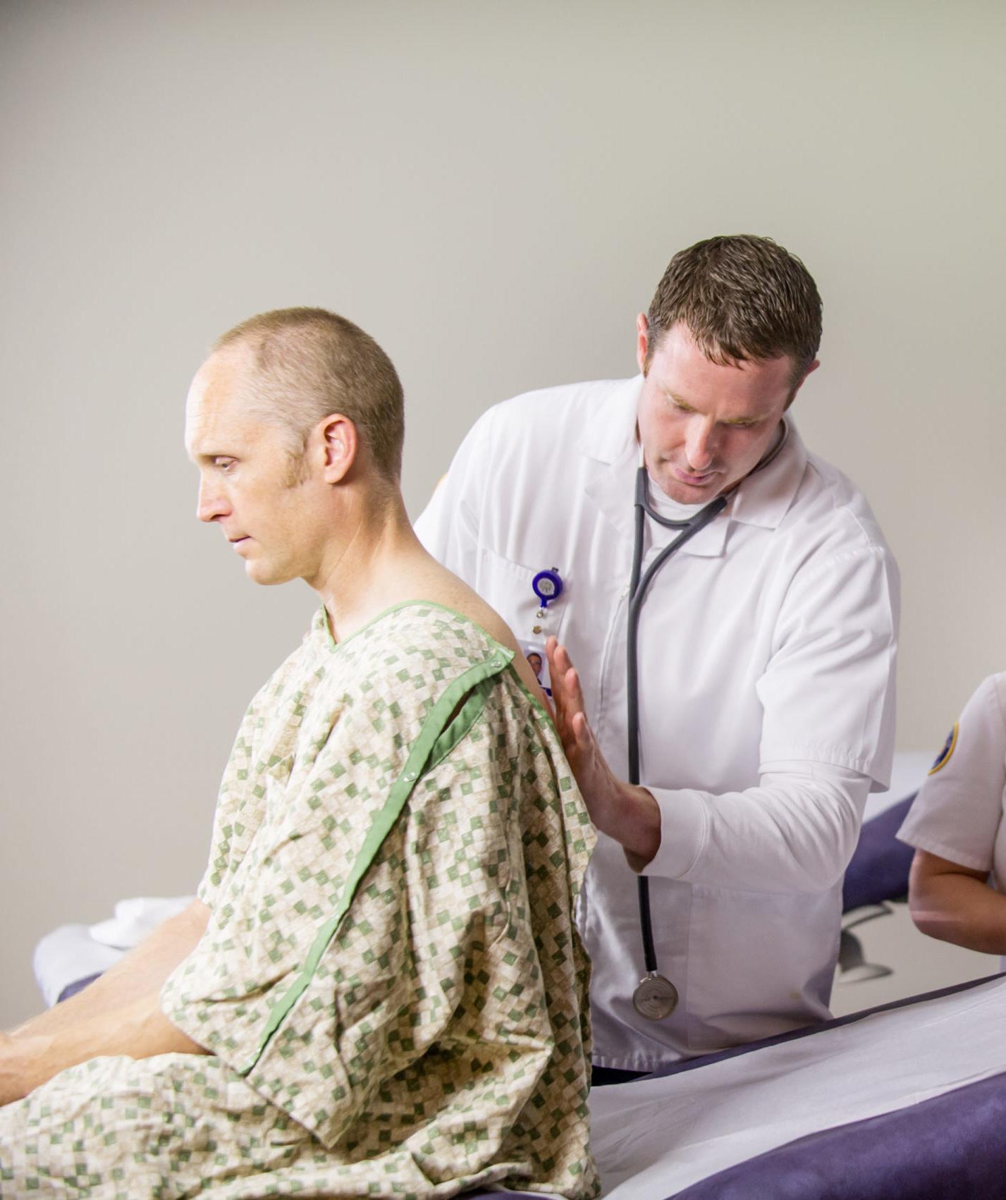 Male nurse examining patient.